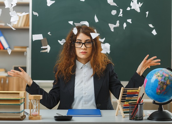 unpleased-spreading-hands-young-female-teacher-.jpg