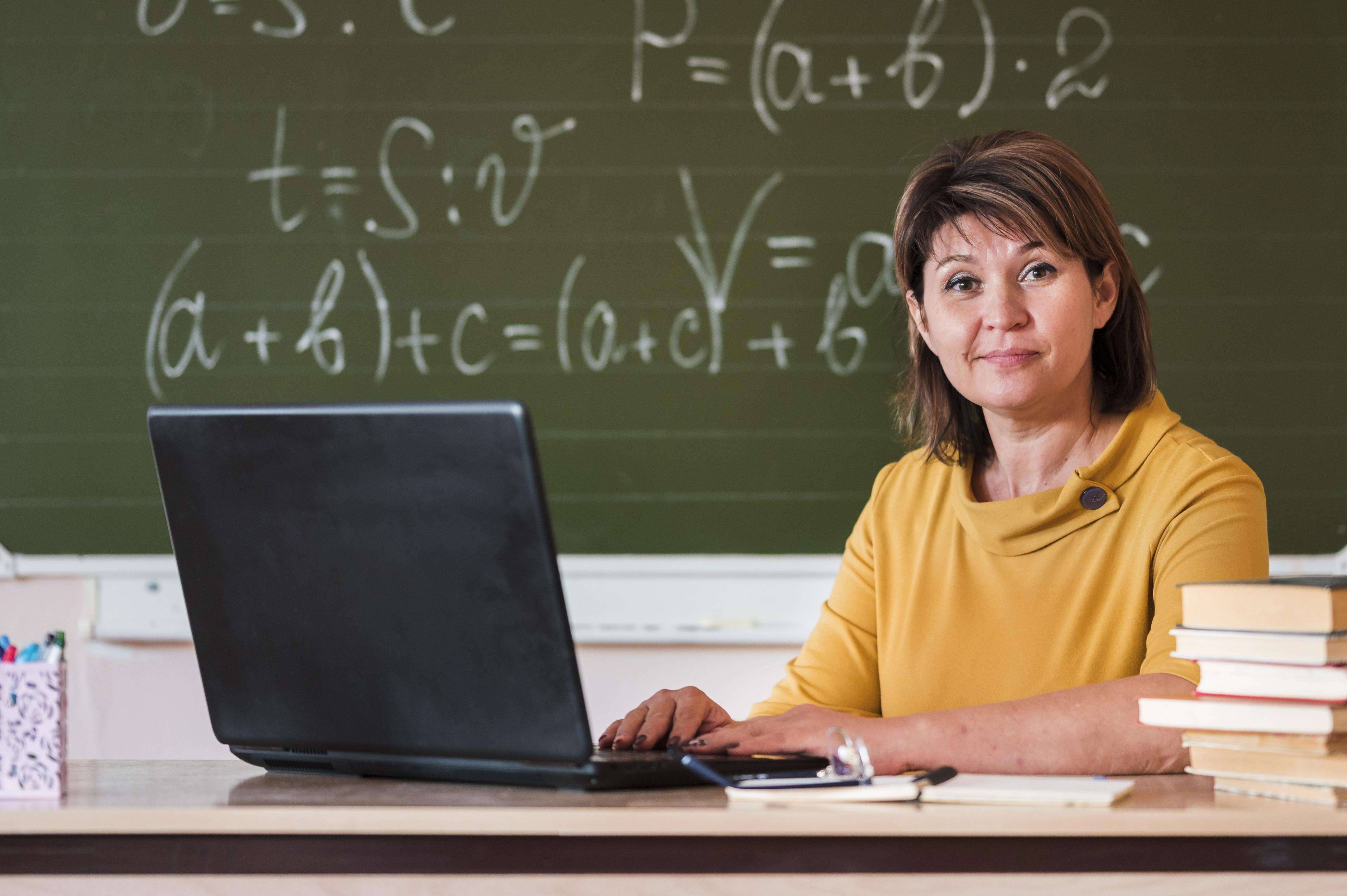 female-teacher-with-laptop-working.jpg